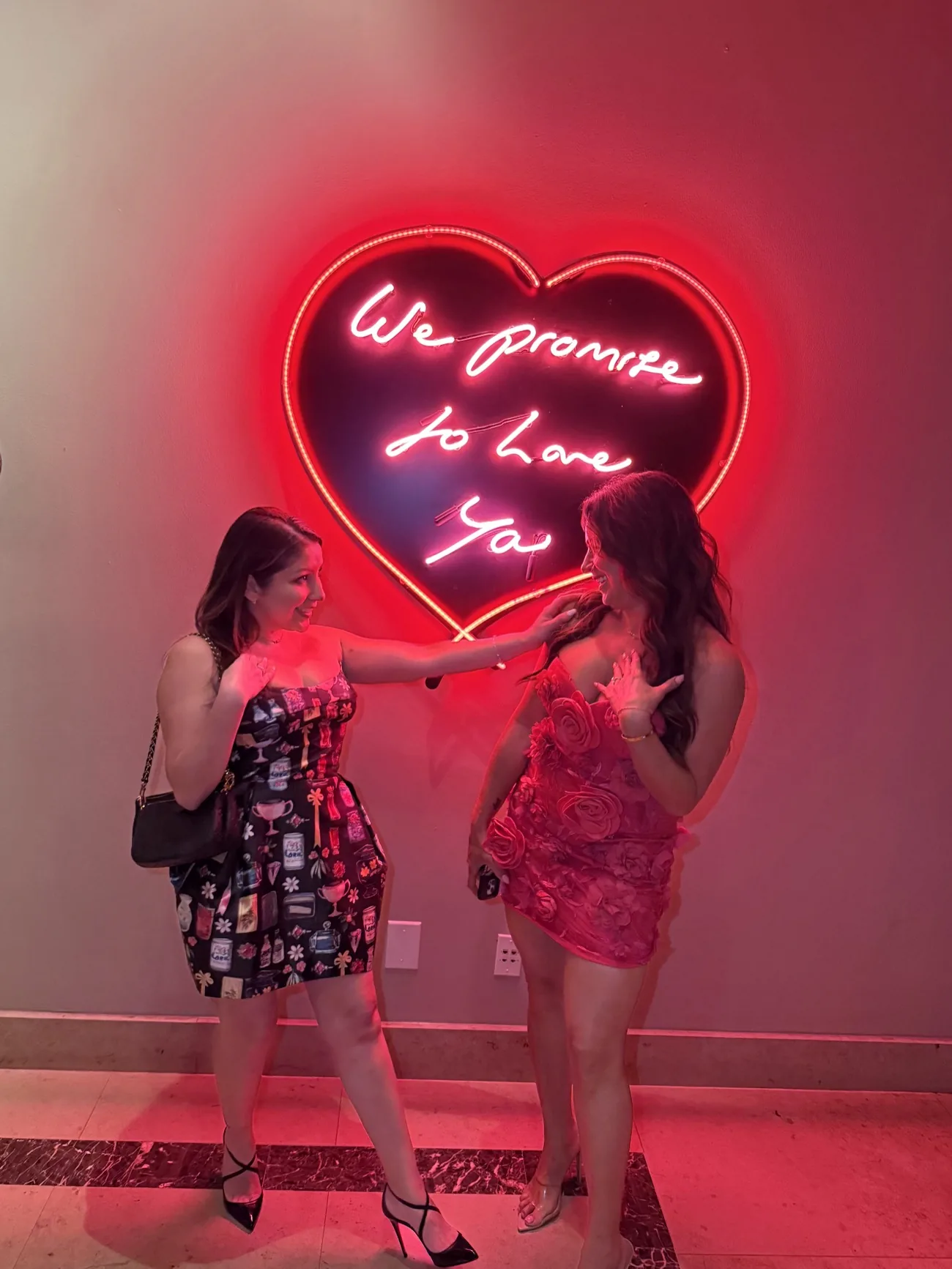 Master stylists Misty Nicole and Elennys Vega together at With Love Hair Studio, beneath the salon's neon &lsquo;We promise to love ya&rsquo; heart